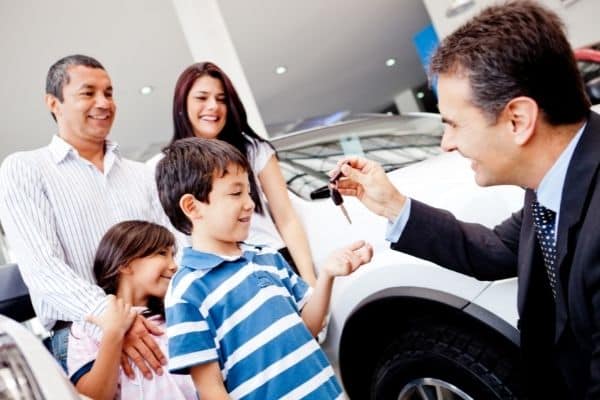 happy family getting a new car
