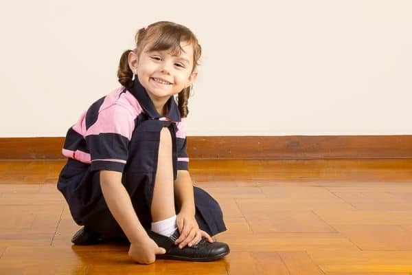 Happy child on school uniform and school shoes