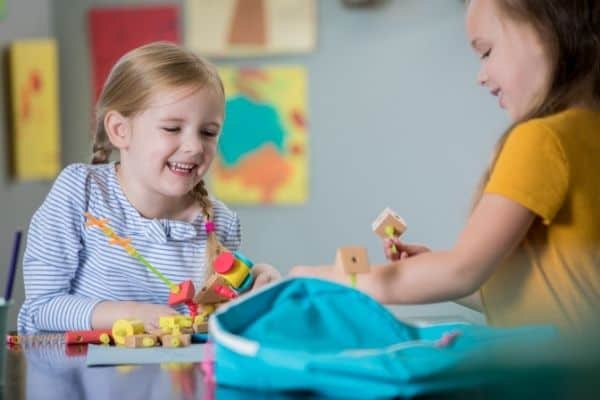 Children laughing while playing with STEM toys