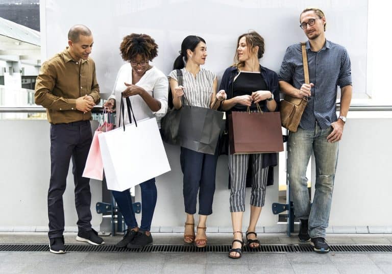 People standing around with shopping bags