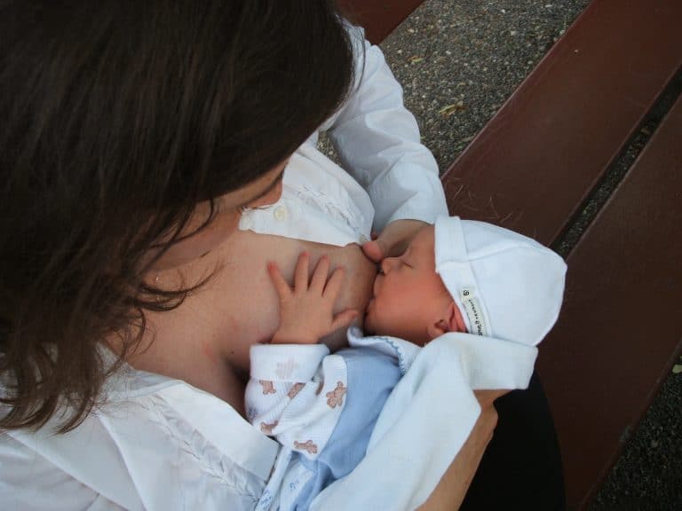 A mum breastfeeding her newborn baby