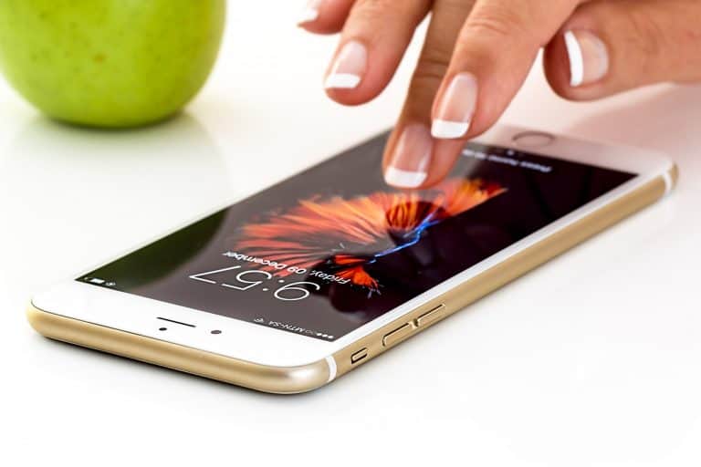 Woman's hand scrolling smartphone with fingertips