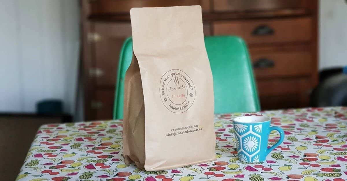Bag of coffee beans and cup of espresso coffee