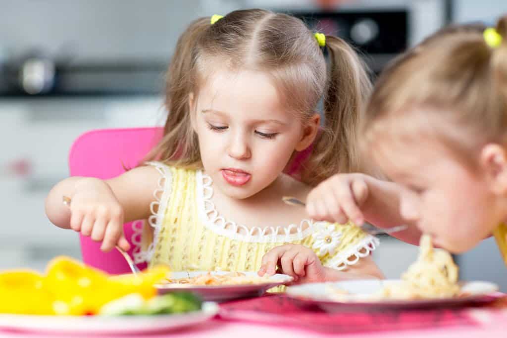 Fussy eaters - two young girls at the dinner table