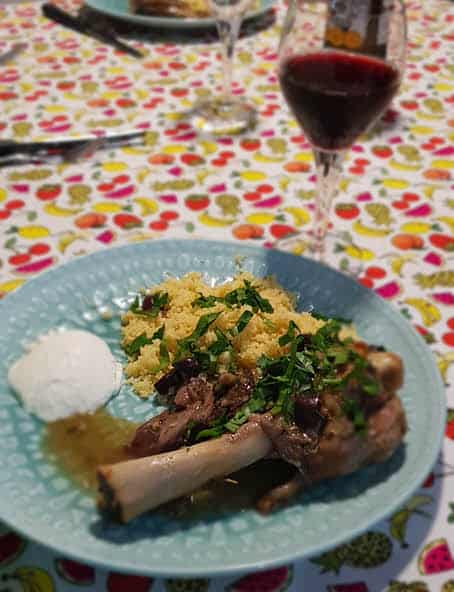 Lemon lamb shanks served with cous cous, greek yoghurt and a glass of red wine