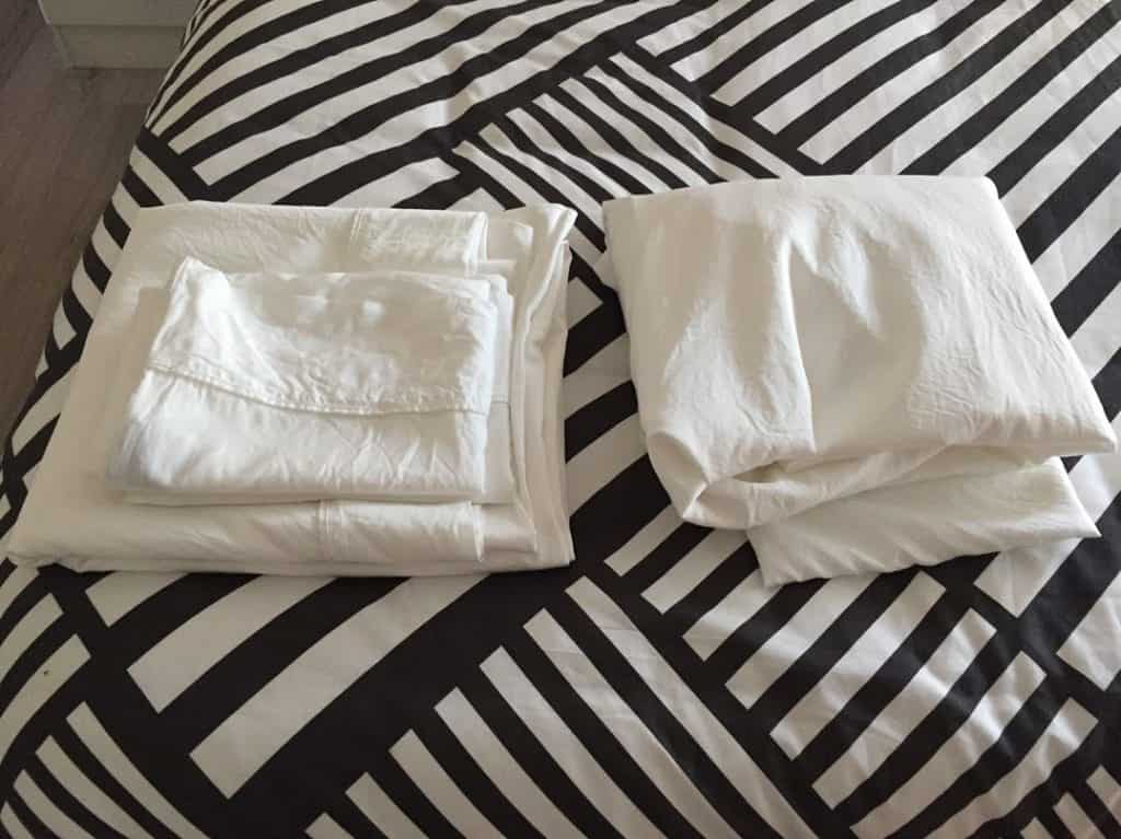 Bamboo sheets from Linenly, folded and laid out on bed