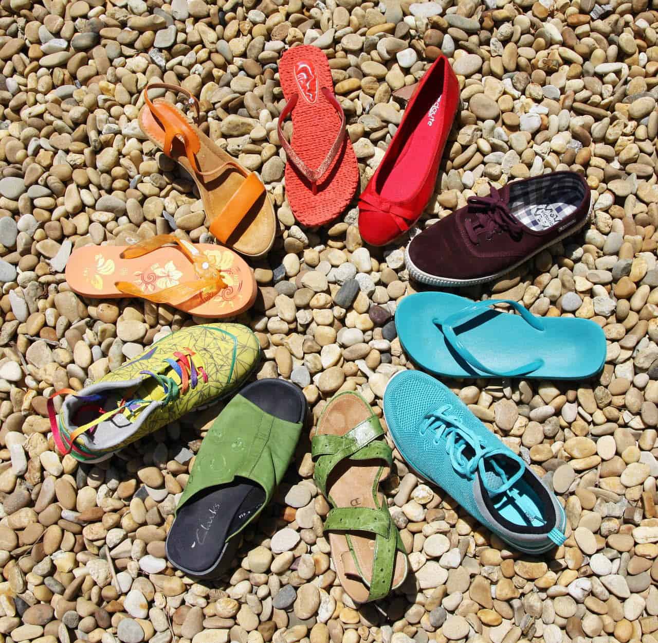 Colourful shoes on pebbles