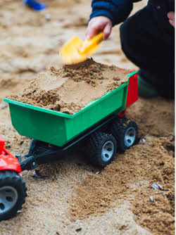 child playing in sand