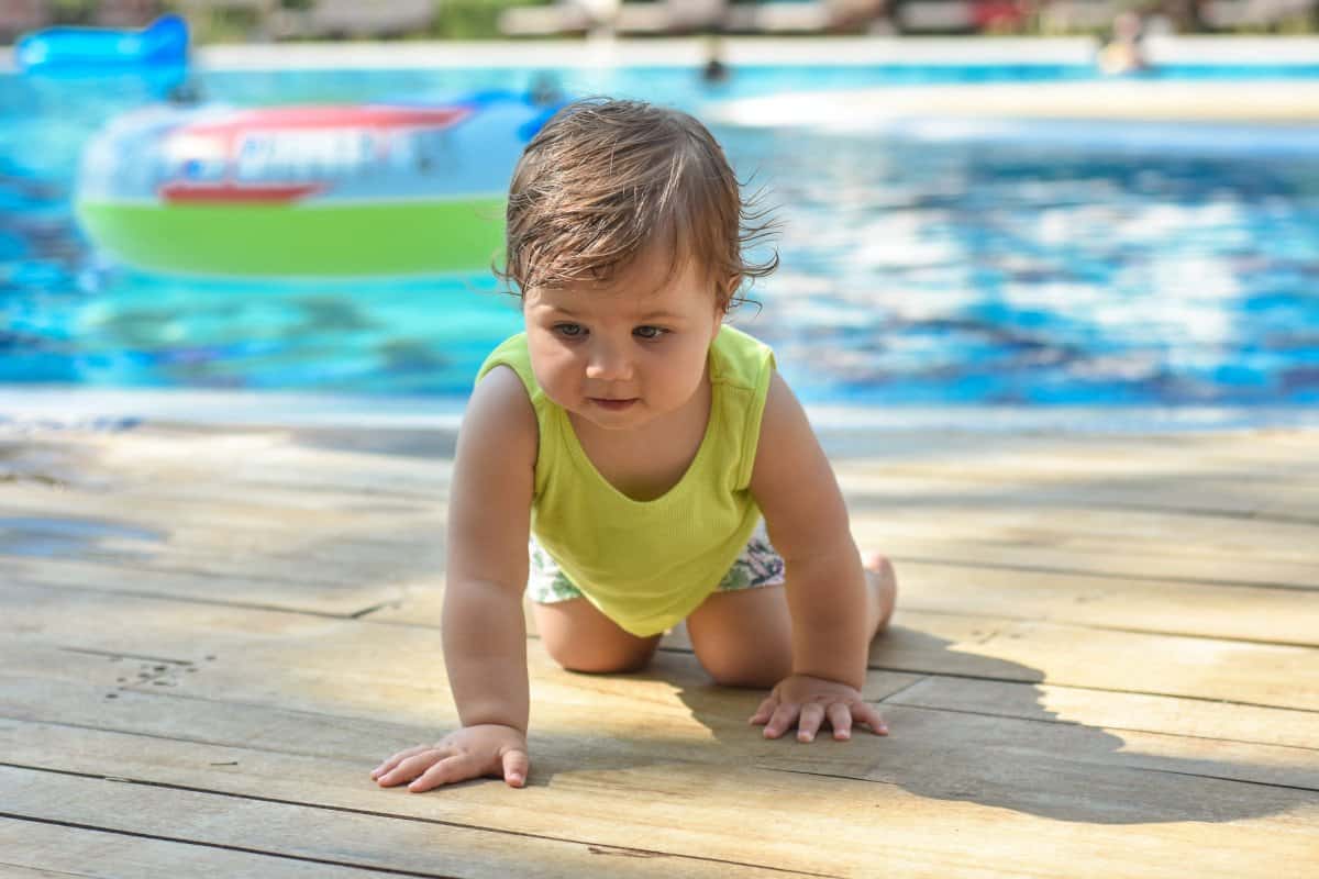 Baby crawling near pool