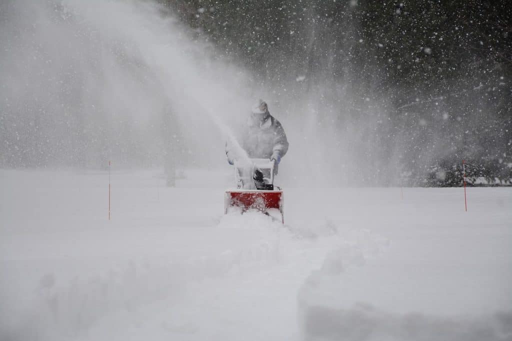 man using snow blower 