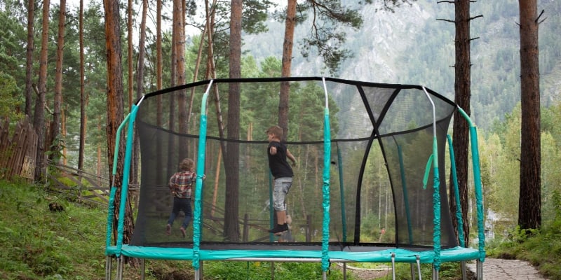 two kids playing on trampoline
