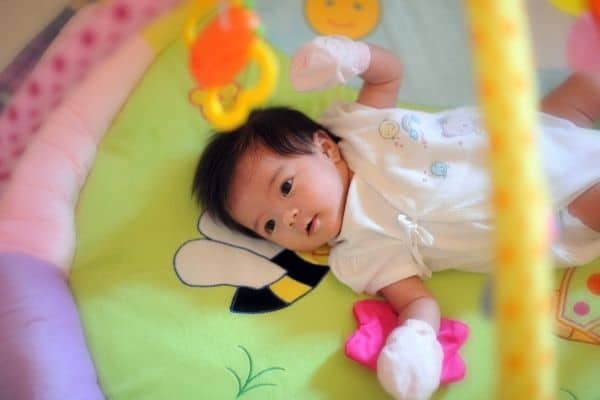 Child on baby play mat