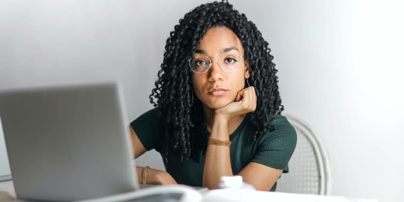 woman thinking while shopping online for year 6 graduation dress