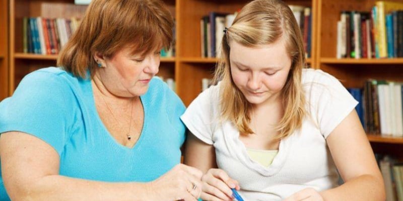 Mum and teenager doing homework
