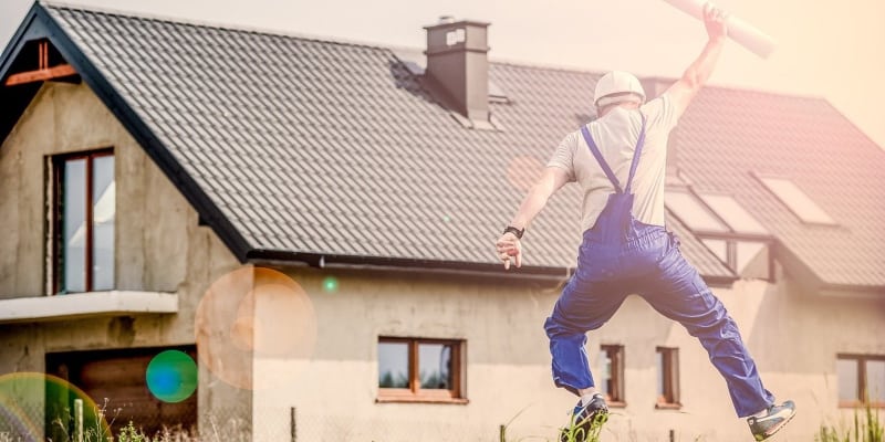 man in front of a house building in progress
