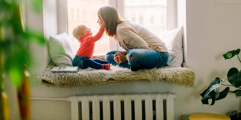 mum and baby playing in a room with heater turned on