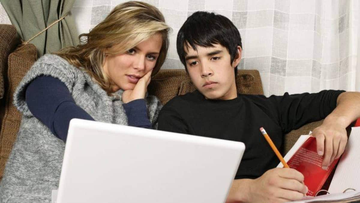 mum helping teenage son with homework