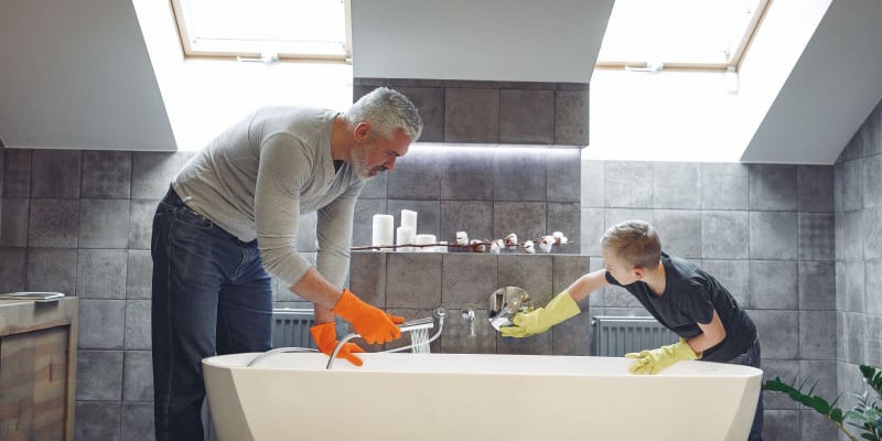 Father and son cleaning the bathroom