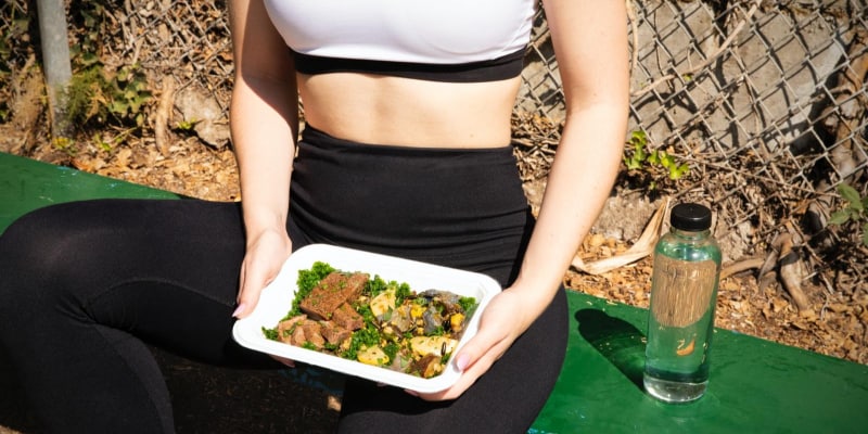 Fit woman holding a plate of healthy and nutritiousfood 