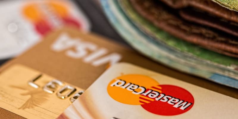 Credit cards and a wallet full of paper money