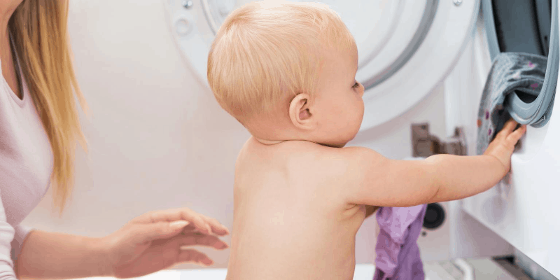 Baby helping mum wash clothes
