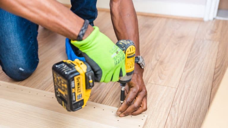 Professional handyman with glove holding a drill