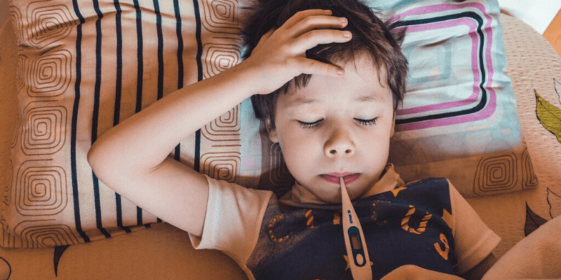 Sick child getting temperature checked