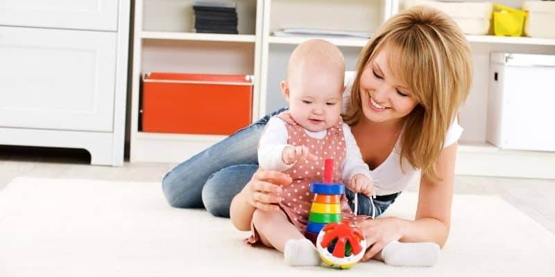 Mother and baby playing with baby toys