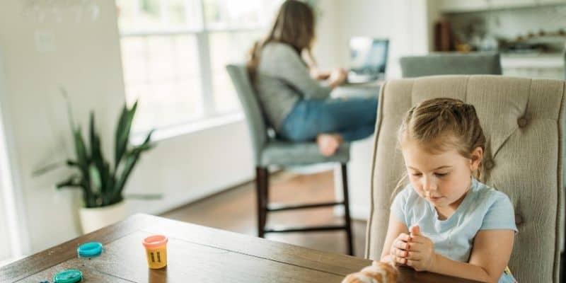 Child playing while mum is working