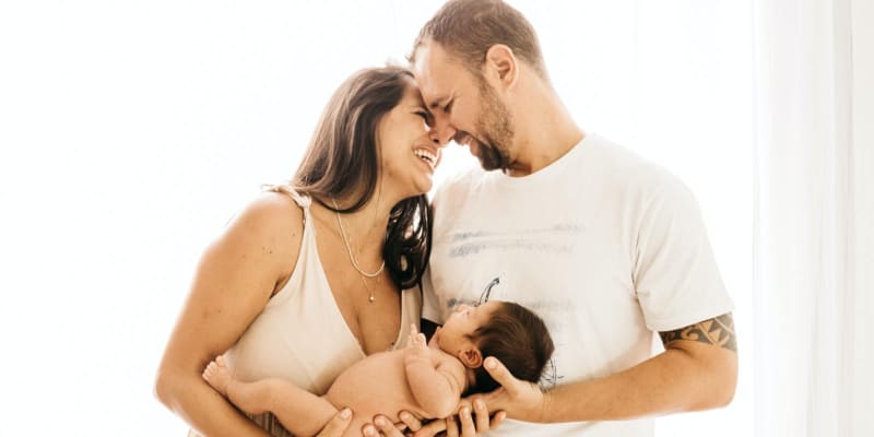 Happy parents holding their newborn
