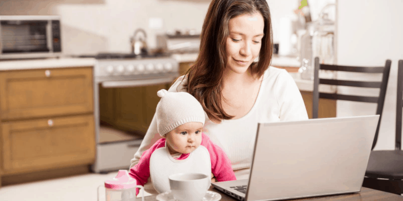 Mum working at home while taking care of baby