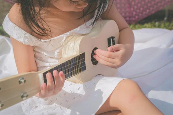 girl playing ukelele
