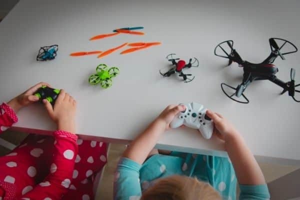 Children playing with drones for kids