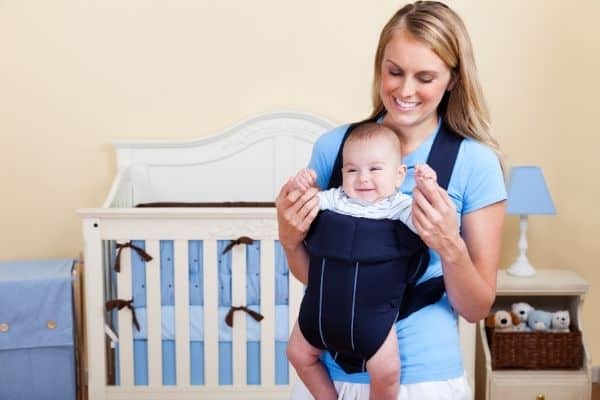 Woman with child on baby carrier