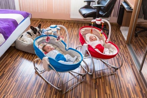 Babies on blue and red baby swings