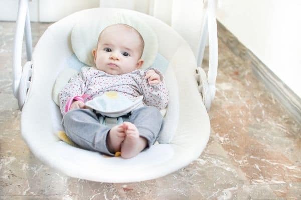 Adorable baby on baby swing