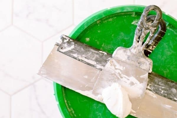 jointing compound on metal scrape and green lid