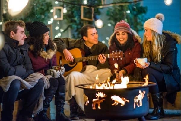 People in the backyard gathered around firepit