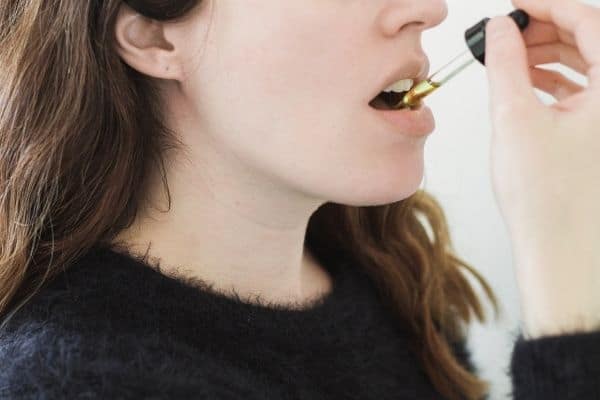 Woman taking cbd oil