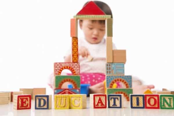 Child playing wooden blocks for early education