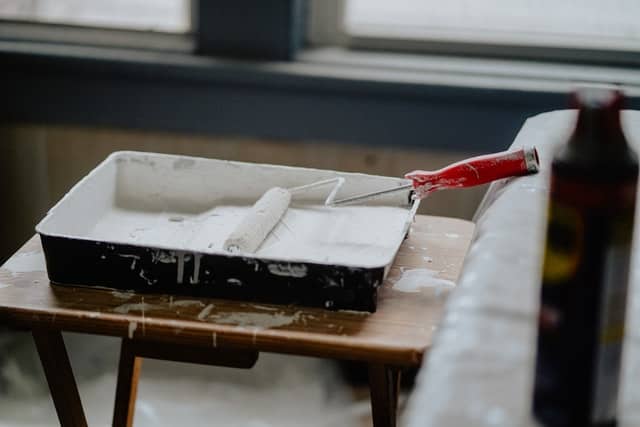 White paint and paint roller for home improvement