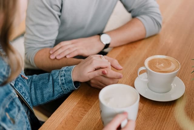Couple talking while having a cup of coffee