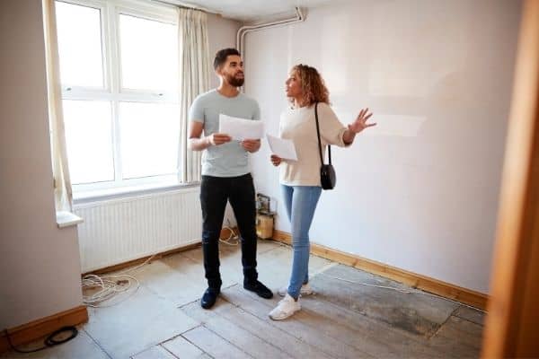 couple inspecting house property