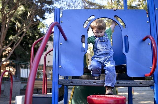 child playing on commercial playground
