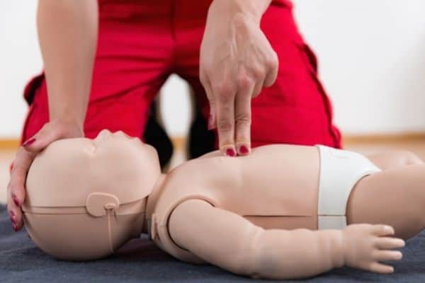 training how to do CPR on baby