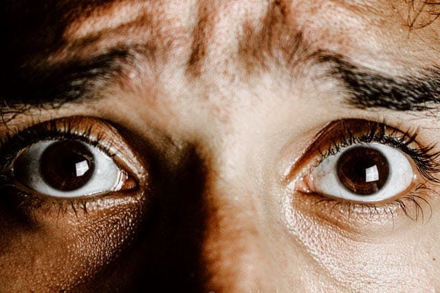 Close up of dark brown eyes and worried expression