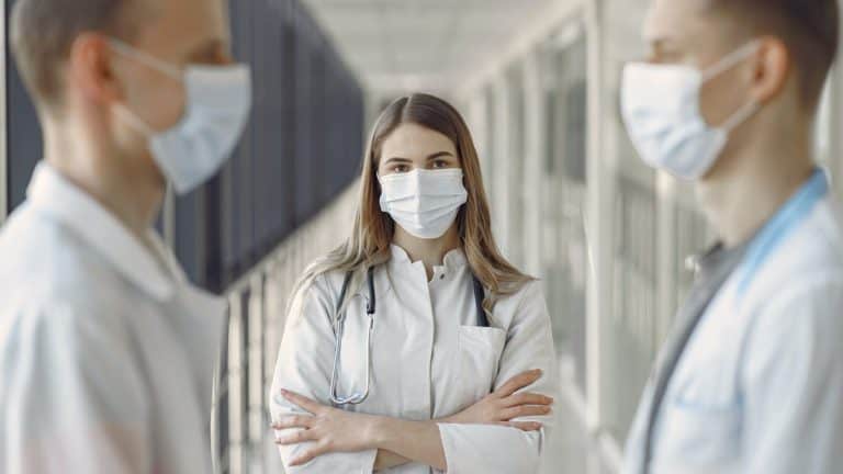 Medical students wearing masks in corridor