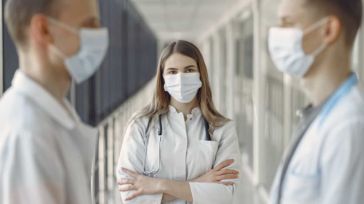 Medical students wearing masks in corridor
