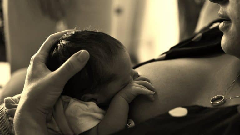 Mother breastfeeding baby - sepia photo