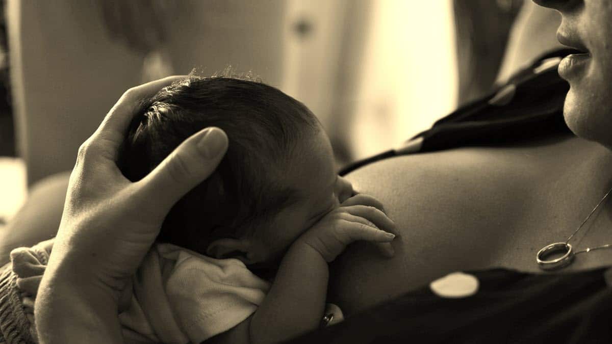 Mother breastfeeding baby - sepia photo